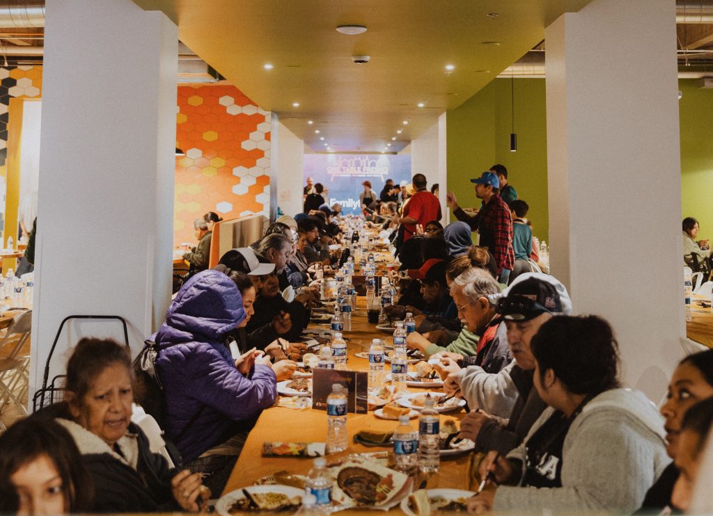 Families sharing a meal at One Table inside City Center