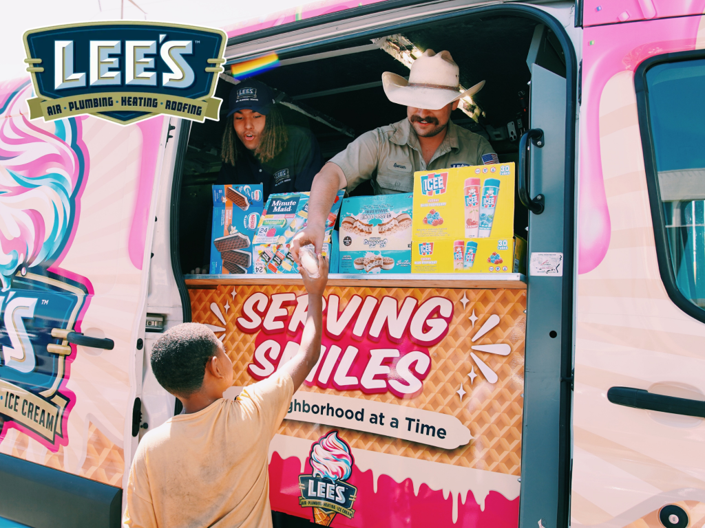 Lee's Ice Cream truck serving dessert to a child.