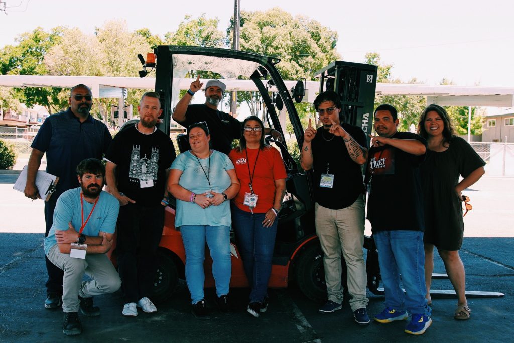 Student celebrating their forklifting certification, pictured with Kimiko Peterson, Director of Career Pathways