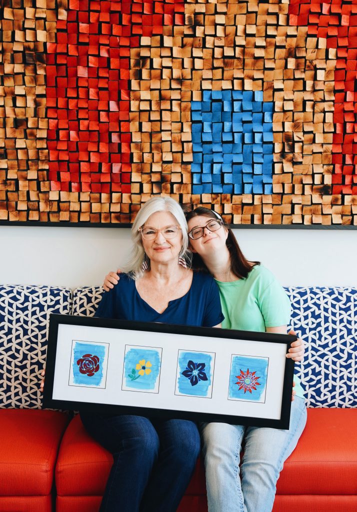 Haley and Jo Whipp holding Haley's framed artwork.