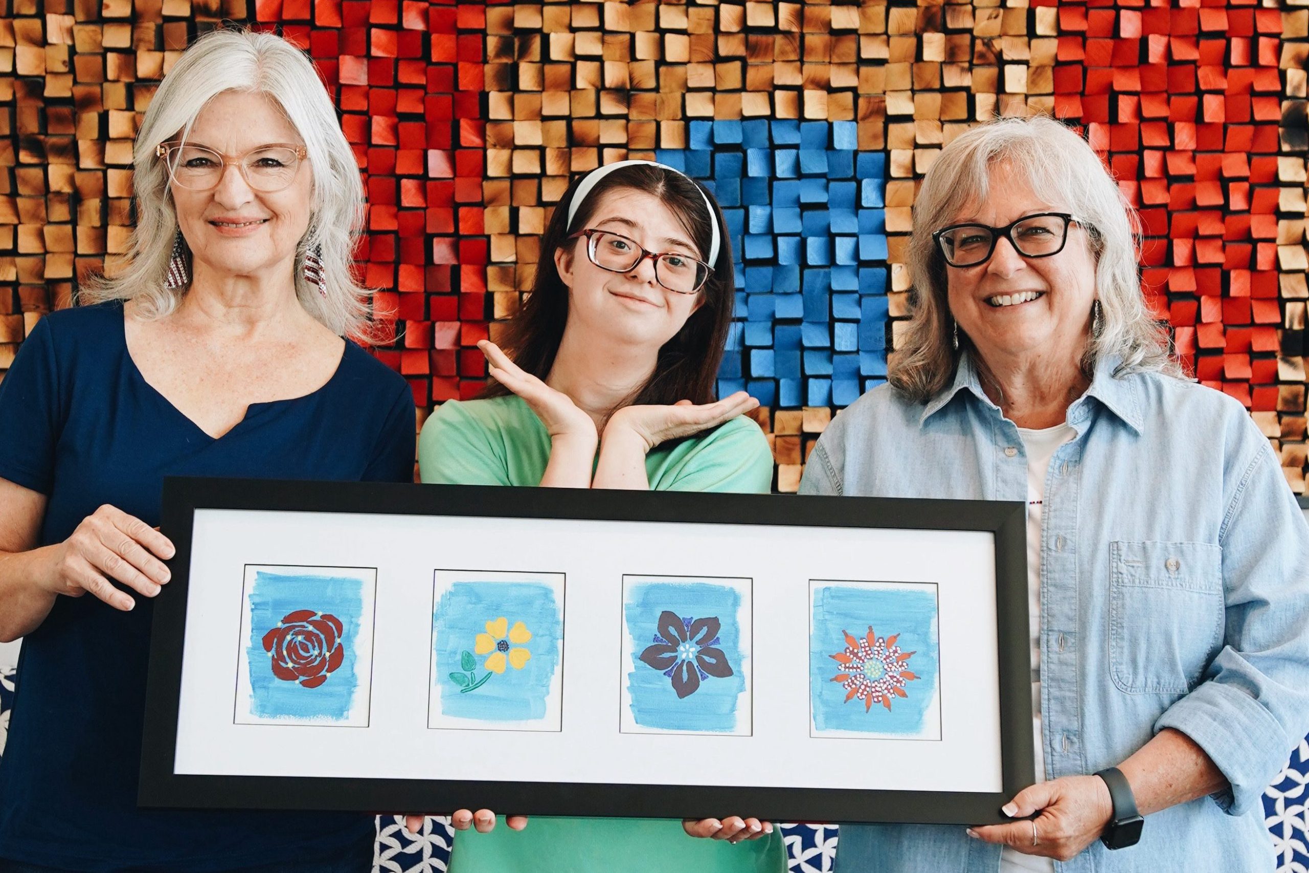 Jo, Haley and Paula holding Haley's framed art work.